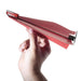 Power Up Red paper airplane with 'Power Up' branding held by a hand on a white background