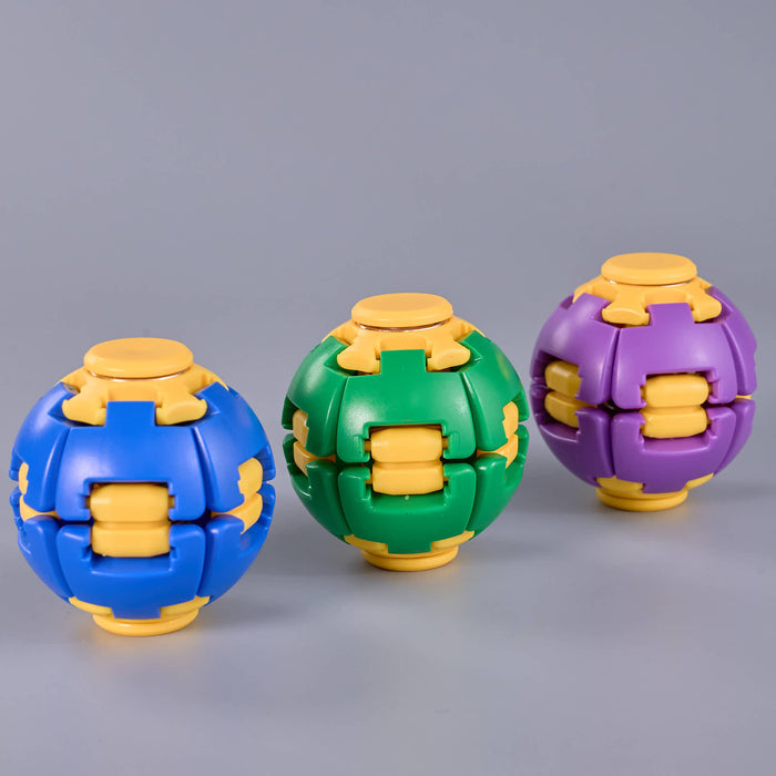 Three spherical puzzle balls in blue, green, and purple, each with yellow inner sliding compartments, arranged on a smooth gray background. Fidgit Sphere Spinner