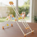 Beaver wooden Toy structure made of interlocking pieces on a wooden surface with a blurred outdoor background