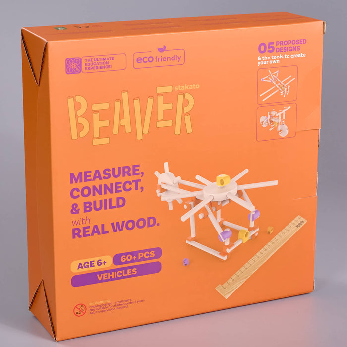 Beaver building kit box in bright orange, showing the product packaging with a white wooden beaver structure and purple text on a light gray background.