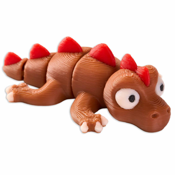 Toy dinosaur with red spikes on a white background
