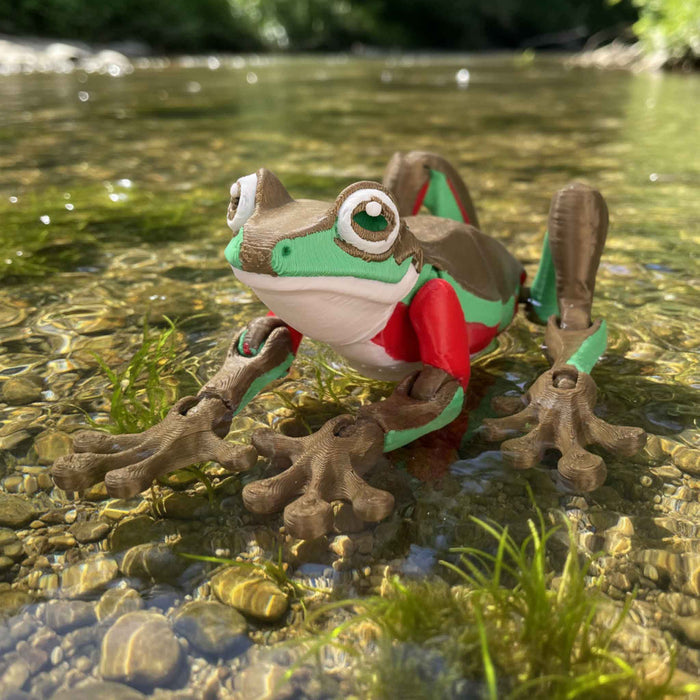 Blue M frog from Heebie Jeebies with a red shirt in clear water