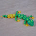 Toy Heebie Jeebies 3D Gecko with green and yellow pattern on a wooden surface