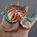 Heebie Jeebies 3D Toy turtle held in a hand against a neutral background