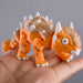 Museum Fidgi Ankylosaurus figurine with spikes held in a hand against a gray background