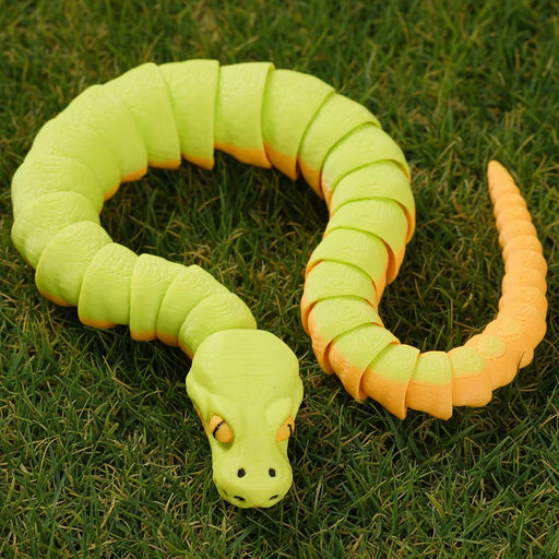 heebie jeebies 3D snake with green and orange segments on grass