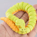 Heebie Jeebies 3D Green and orange snake-shaped toy held in a hand against a gray background