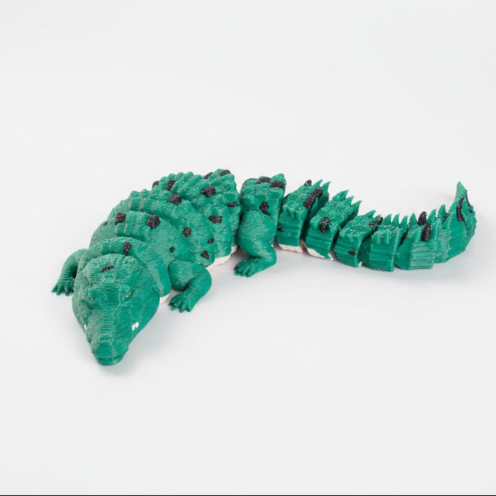 Green toy alligator on a white background