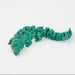 Green toy alligator on a white background