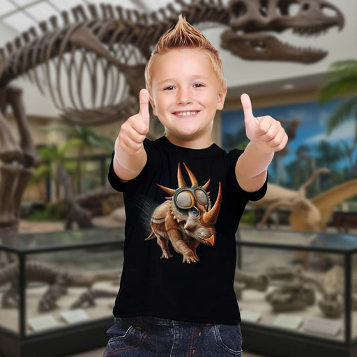 Child wearing a black t-shirt with a dinosaur graphic, pointing at the design from Heebie Jebies