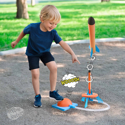Child playing with a toy rocket and launch pad in an outdoor setting